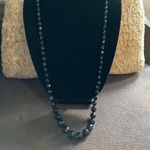 Long black beaded necklace, vintage. Beats cold to touch.